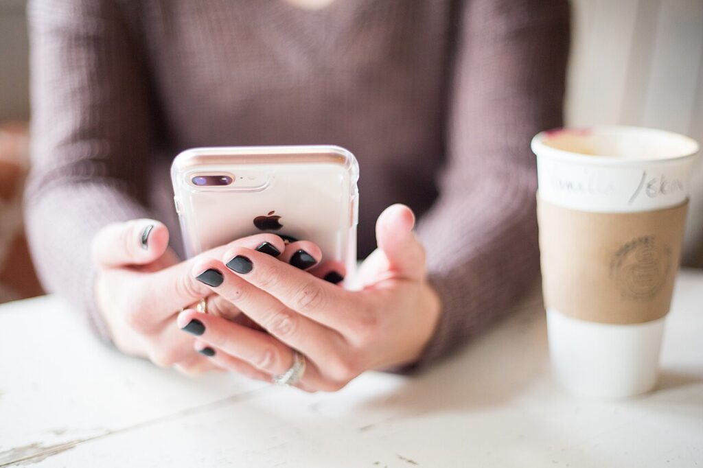 A woman using a smartphone; illustrative image for dating-app safety